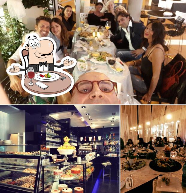Guarda la foto che raffigura la tavolo da pranzo e cibo di Cafè Noir