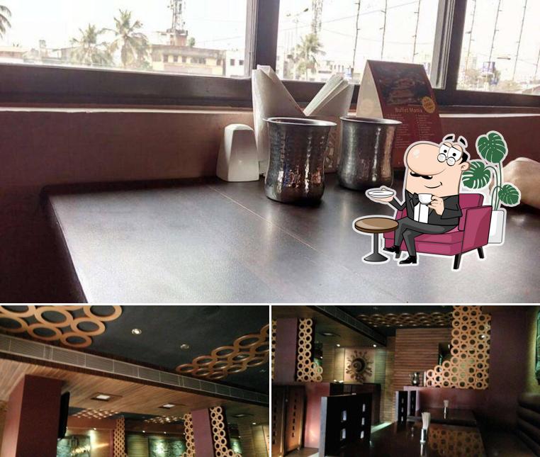 Take a seat at one of the tables at Sanjha Chulha Restaurant and Banquet Hall