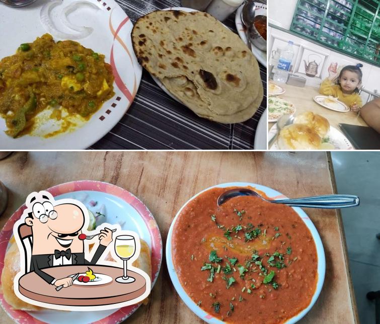 Check out the image depicting food and dining table at Greens Veg Restaurant