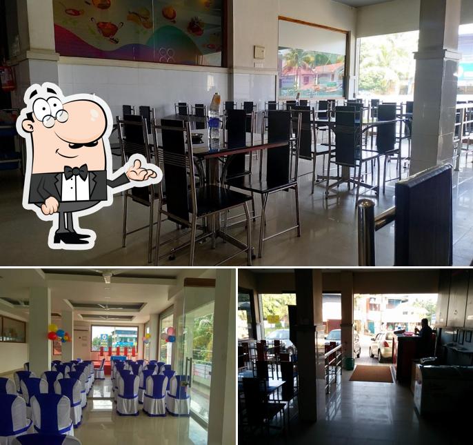 Take a seat at one of the tables at AM Malabar Restaurant