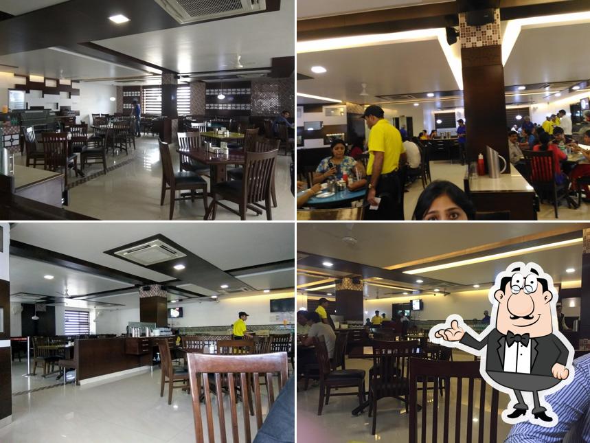 Take a seat at one of the tables at Manohar Dairy & Restaurant - MP Nagar