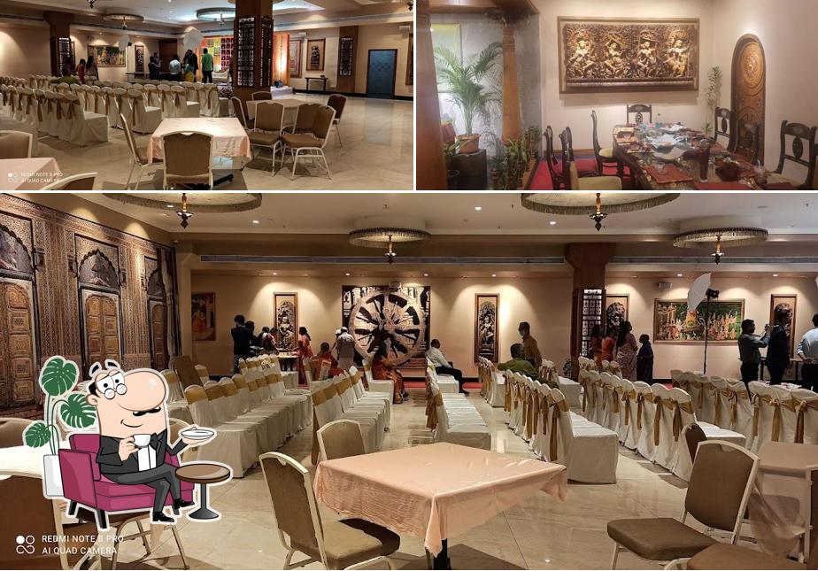 Take a seat at one of the tables at Annalakshmi Restaurant