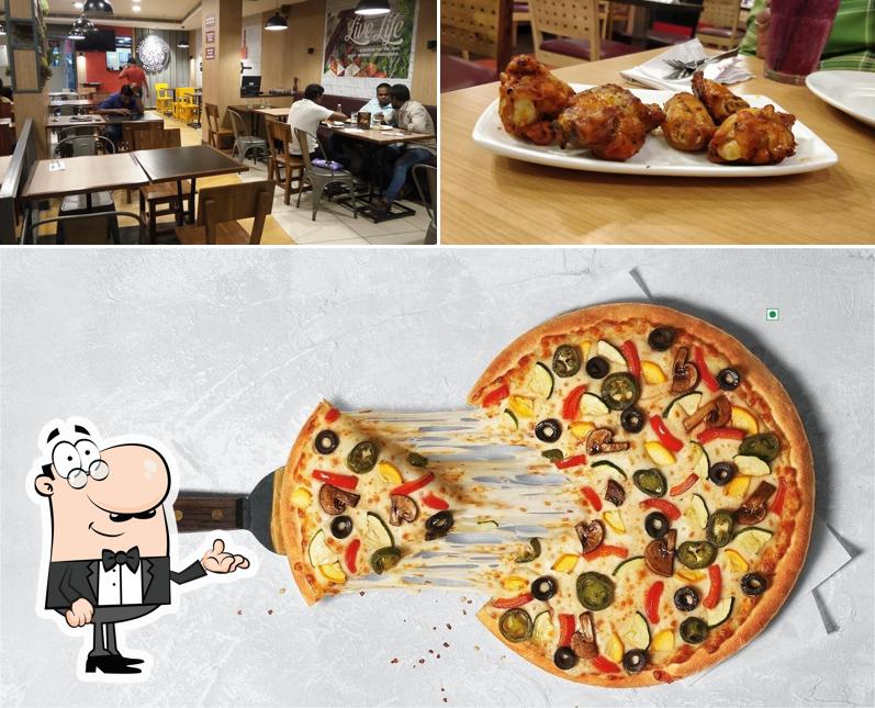 Check out the image displaying interior and food at Pizza Hut Vizag, Vishakapatnam