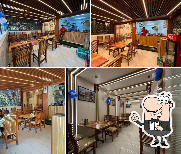 Take a seat at one of the tables at Hotel Kadalu Teera