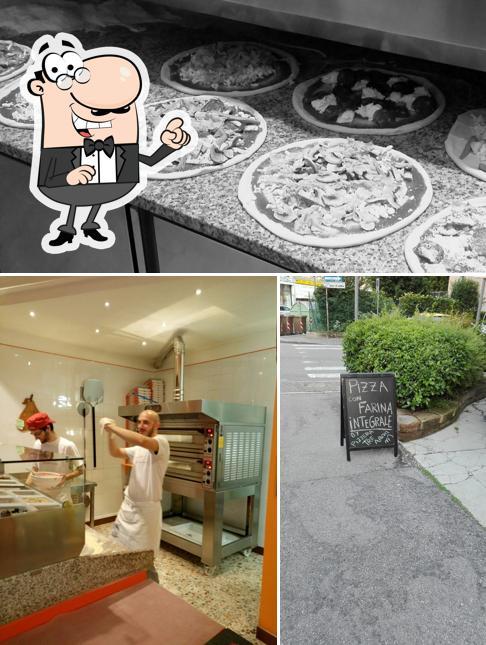 La foto di interni e lavagna da Pizzeria Tre Archi