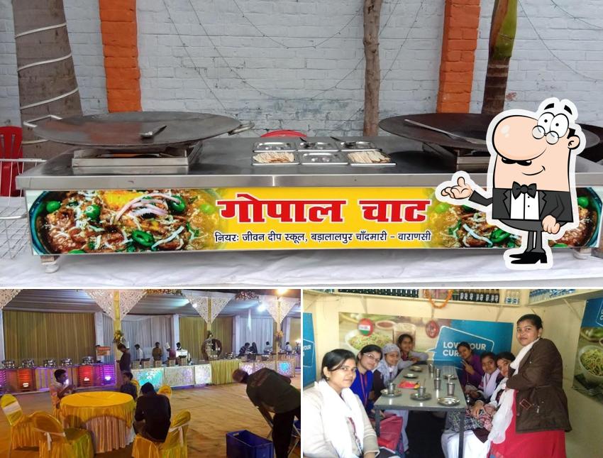 Take a seat at one of the tables at New Kashi Gopal Chat & Ice Cream Parlour