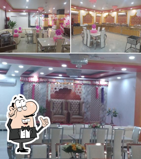 Take a seat at one of the tables at Swagat Banquet & Party Hall