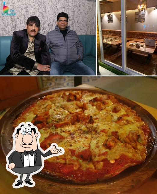 This is the picture displaying interior and pizza at Ek Number - Twisted Indian Cafe