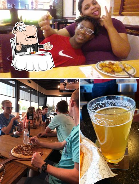 Among various things one can find dining table and beer at Pizza Hut