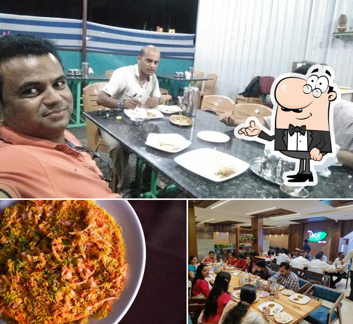 Take a seat at one of the tables at Hotel Aditi Pure Veg