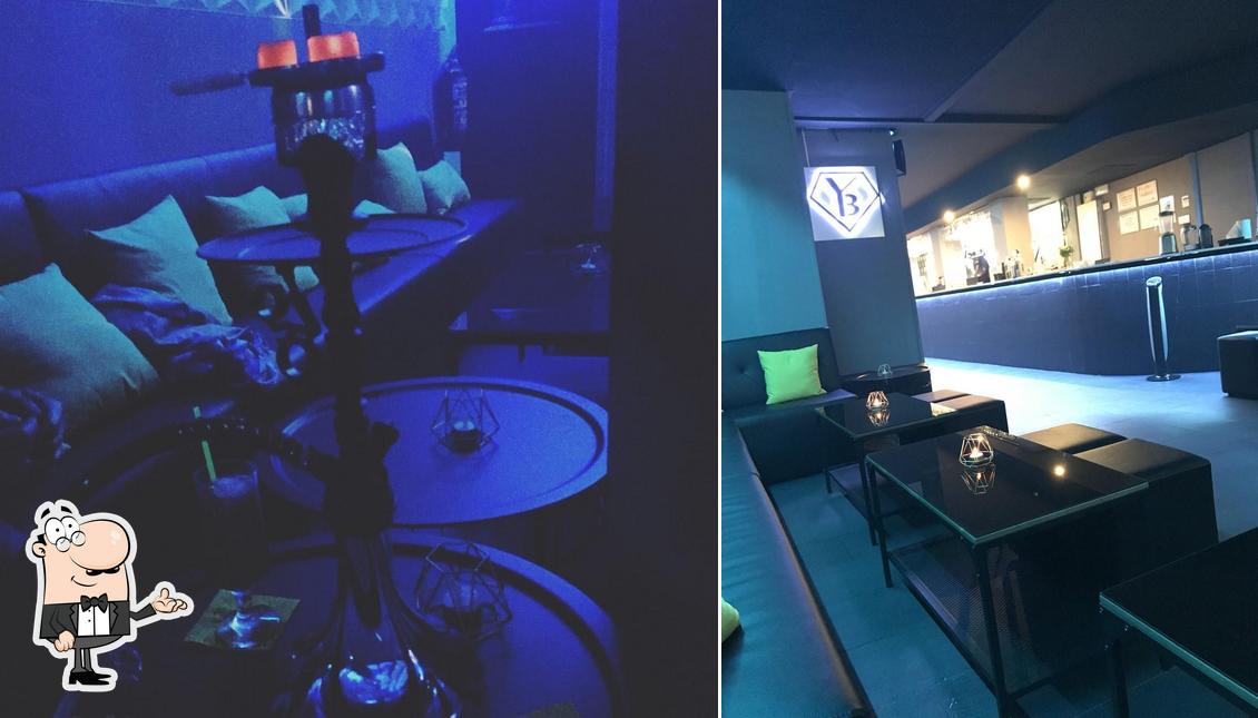 Take a seat at one of the tables at Black And Gold Shisha Lounge