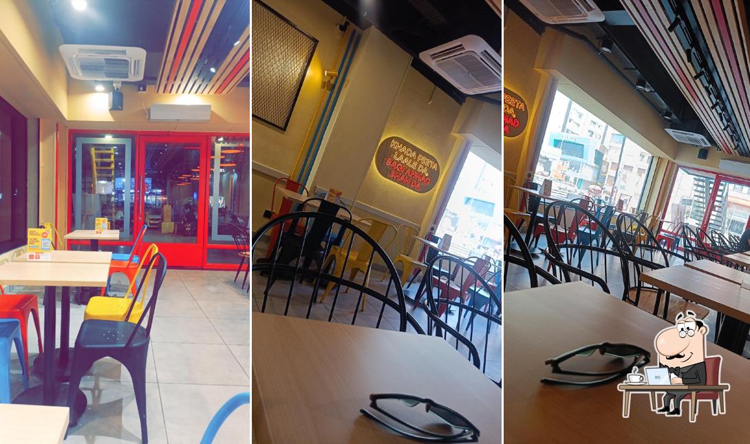 Take a seat at one of the tables at Burger Singh