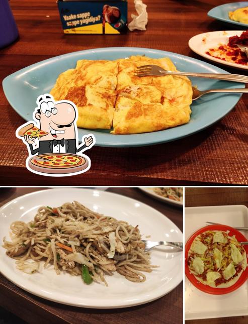 Try out pizza at Cake World Bakery & Restaurant