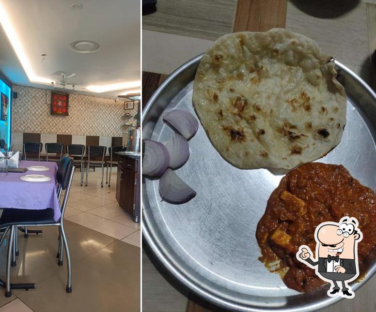Take a seat at one of the tables at Hotel Murali pure veg