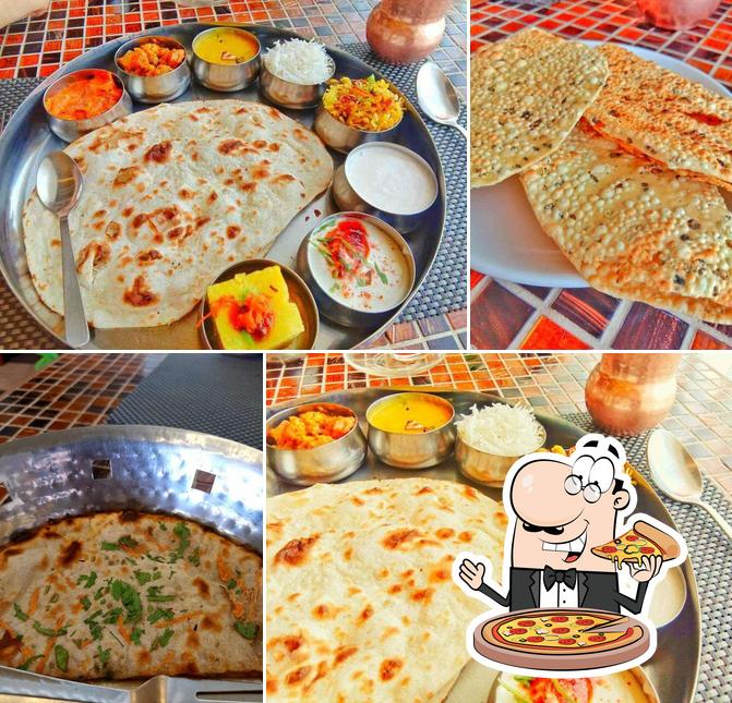 Pick pizza at Santrupti Veg Restaurant and Party Hall