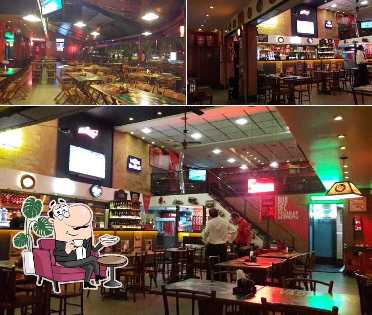 Sente em uma das mesas no Cevadas S.A. Bar