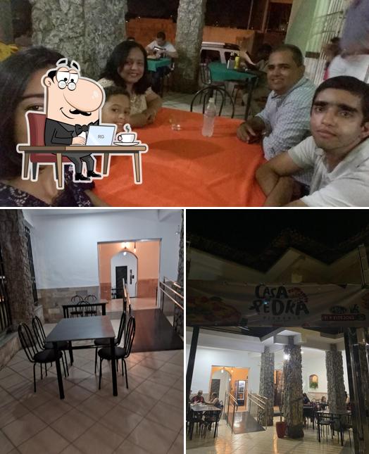 Sente em uma das mesas no Pizzaria Casa de Pedra