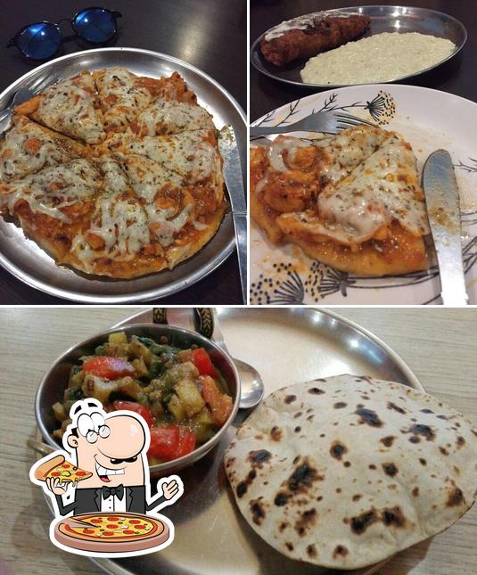 Get pizza at Spicy Bites Restaurant