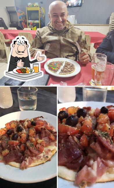 A imagem do Cascata Pizzas - Caramuru’s comida e mesa de jantar