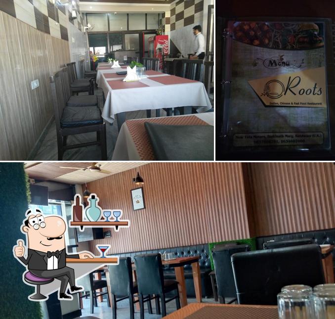 Take a look at the image depicting interior and alcohol at Roots pizza house Restaurant