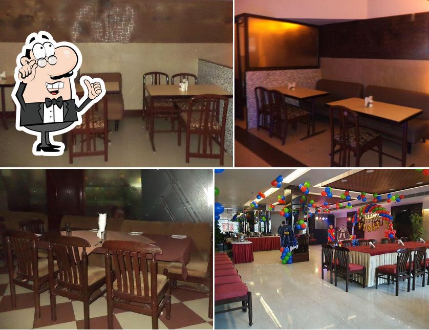 Take a seat at one of the tables at Hotel Nilgiri Restaurant
