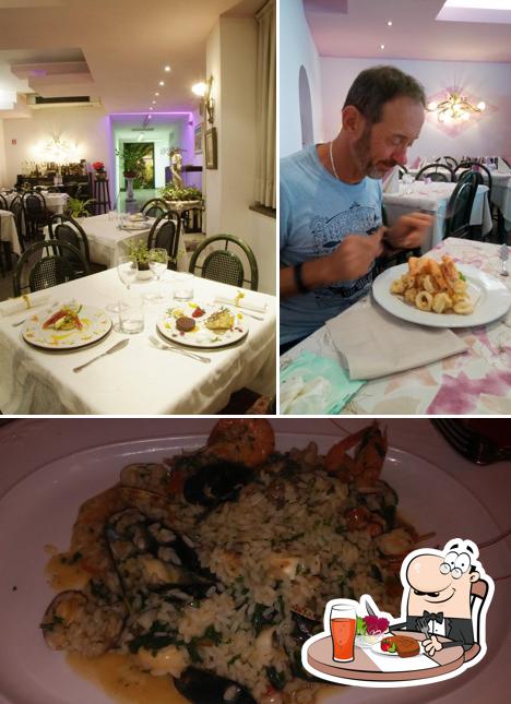 Tra le varie cose da Ristorante Lo Scoglietto si possono trovare la tavolo da pranzo e cibo