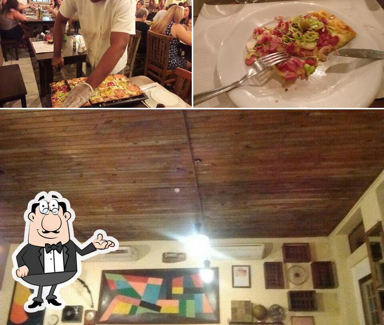 A imagem da interior e comida no Graminha Pizzaria Santos