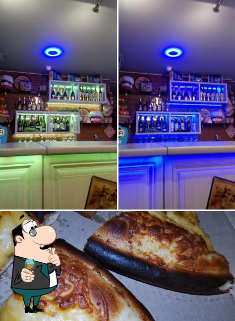 Take a look at the photo depicting bar counter and pizza at Gustov Pizza Food & Drink