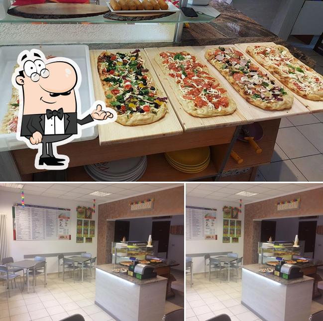 Questa è la immagine che presenta la interni e pizza di La Preferita