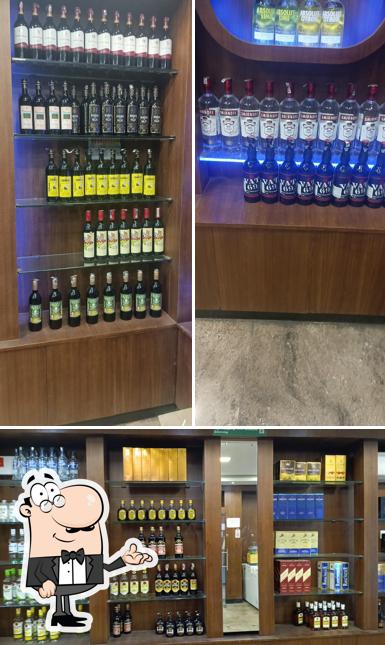 Take a seat at one of the tables at Elite foreign liquor shop tasmac bar club
