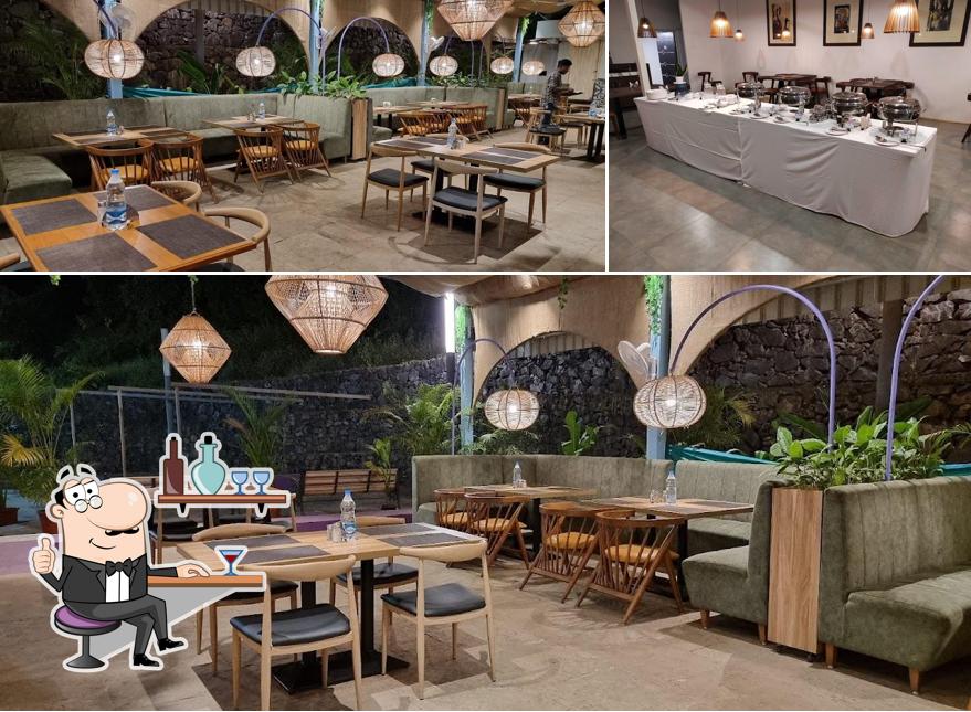 Take a seat at one of the tables at ISHNA Pure Veg-Vegan-Jain, Opp. Morjim Khind Park