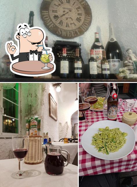 Questa è la immagine che presenta la bevanda e tavolo da pranzo di Trattoria del Duca