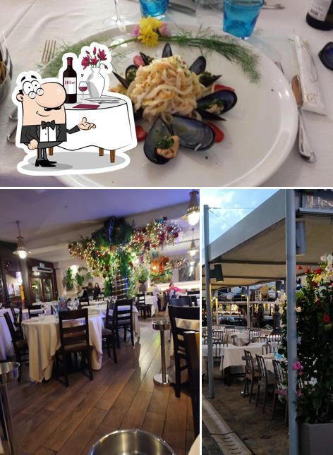 La foto di tavolo da pranzo e cibo da Ristorante da Giuliano al Porto Canale