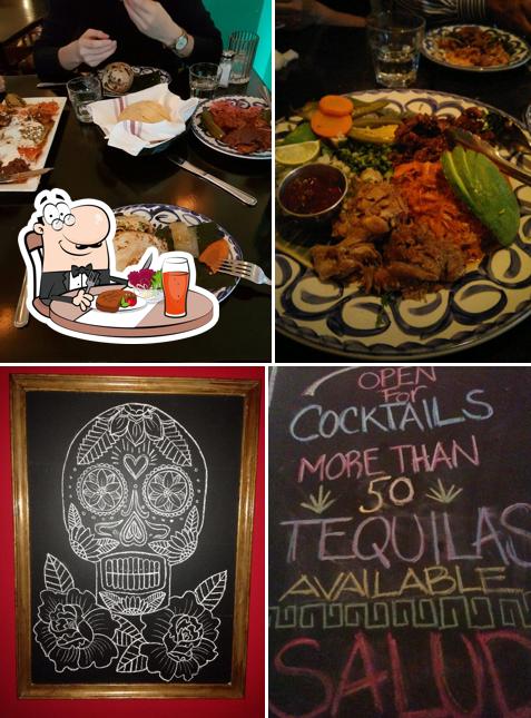 Among different things one can find dining table and blackboard at Milagro Cantina
