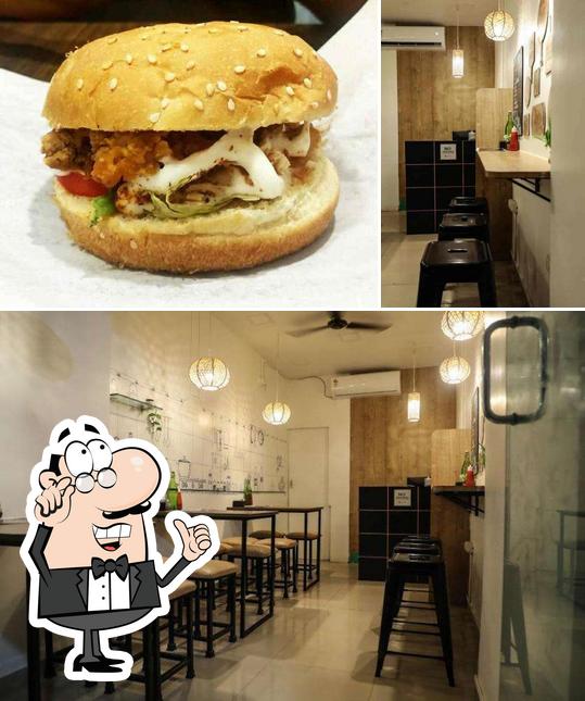 This is the image depicting interior and burger at Cafe Hunger Hub