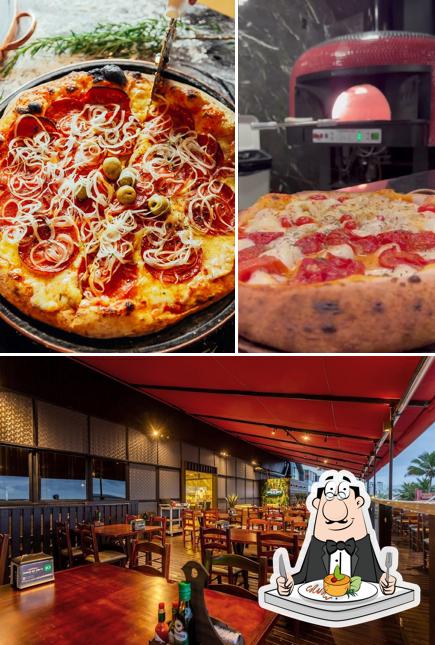 Entre diferentes coisas, comida e interior podem ser encontrados no Pizzaria Coisas do Chico