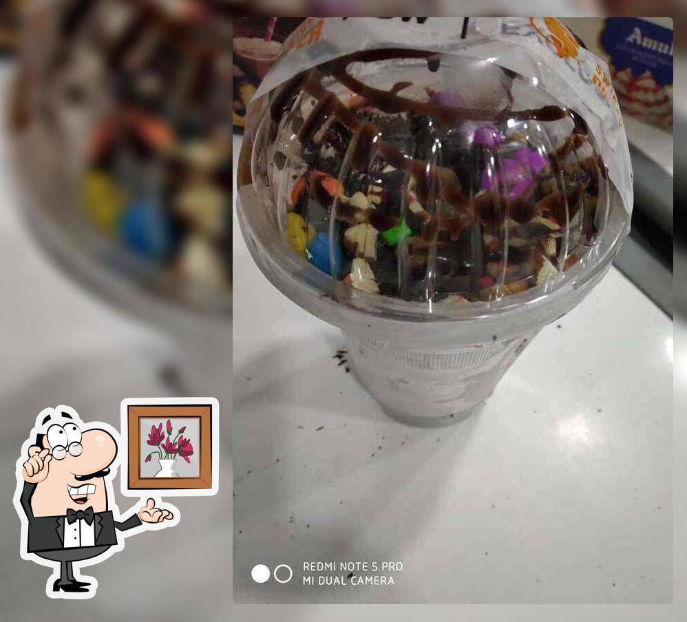 Take a seat at one of the tables at Amul Ice Cream Parlour