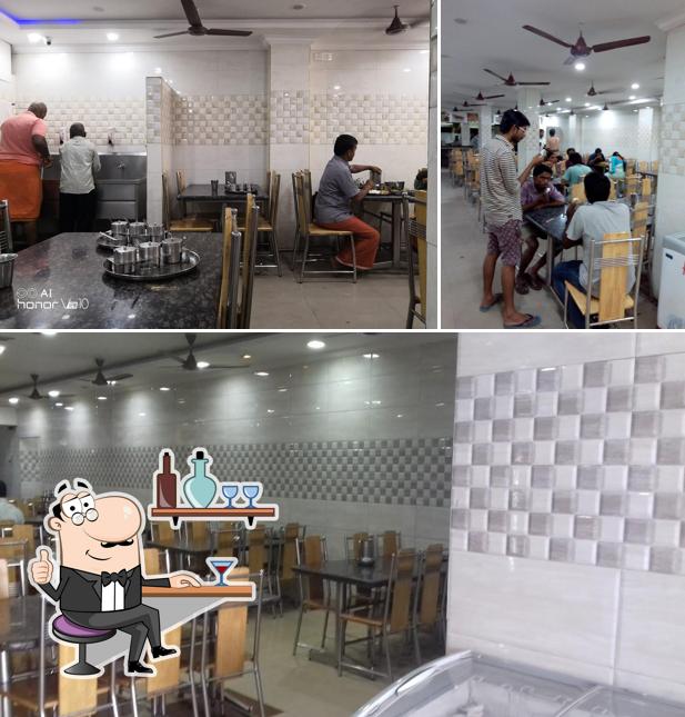 Take a seat at one of the tables at Hotel Saravana Bhavan