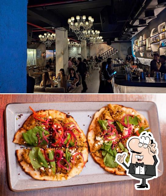 Take a seat at one of the tables at Garnet Plates & Pours Andheri