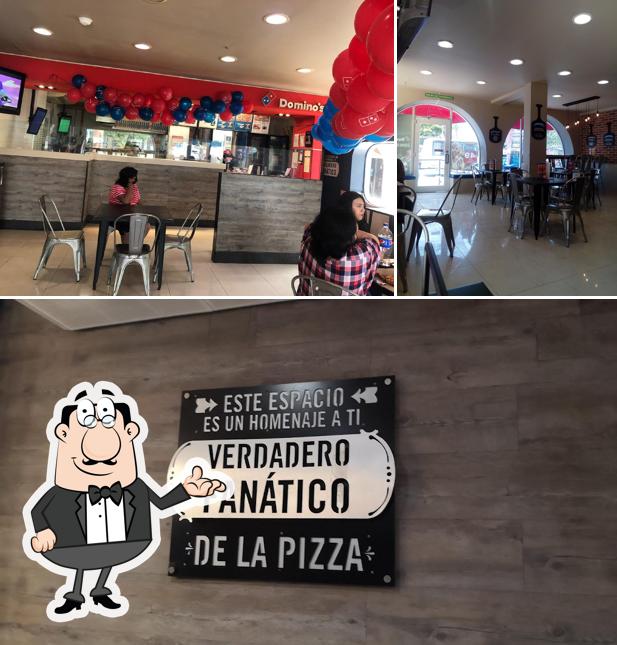 Take a seat at one of the tables at Domino's Playa Del Carmen