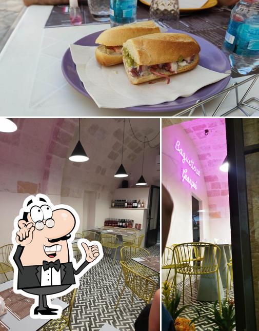 Check out the picture displaying interior and sandwich at Baguetteria da Gianpiè