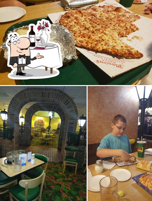 This is the image depicting dining table and pizza at Marion's Piazza