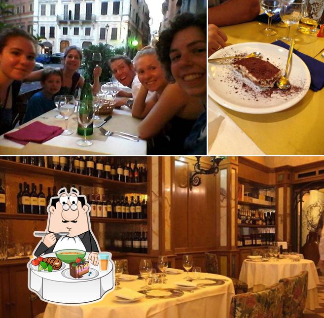 Guarda la foto che mostra la tavolo da pranzo e interni di Enoteca Capranica