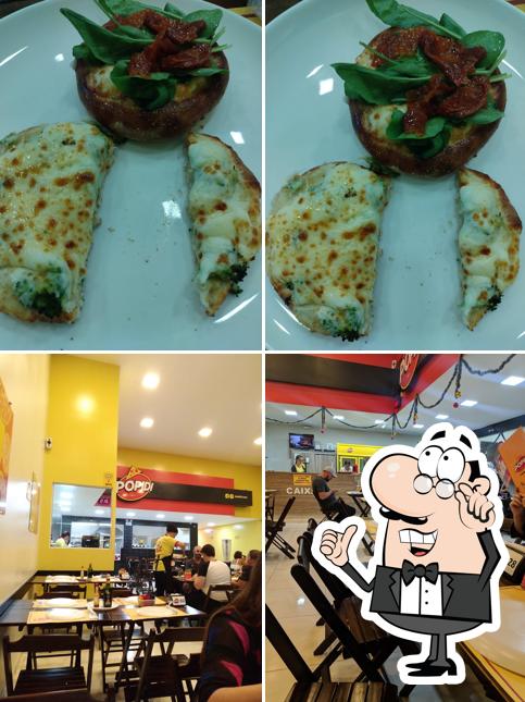 Confira a foto ilustrando interior e comida a Pópidi Pizzaria