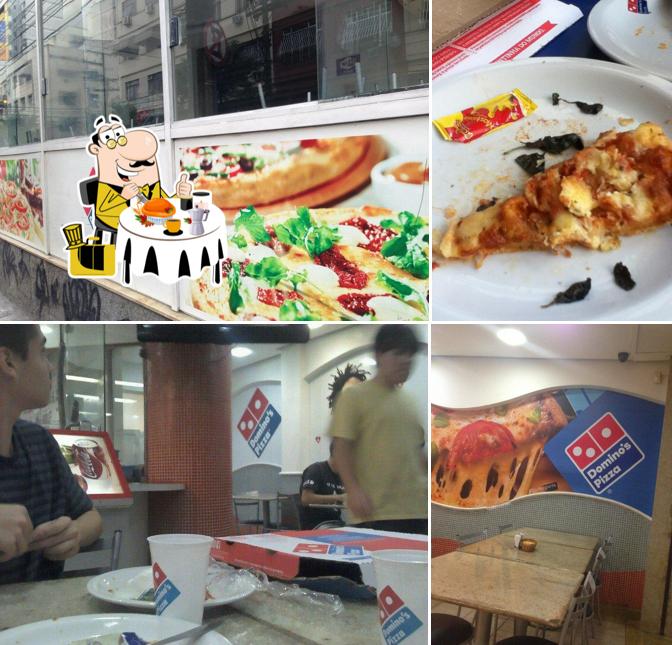 Dê uma olhada a imagem mostrando comida e interior a Domino's Pizza