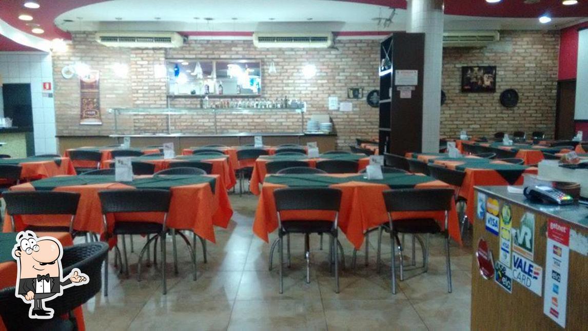 Sente em uma das mesas no Restaurante e Pizzaria Bella Sonatta