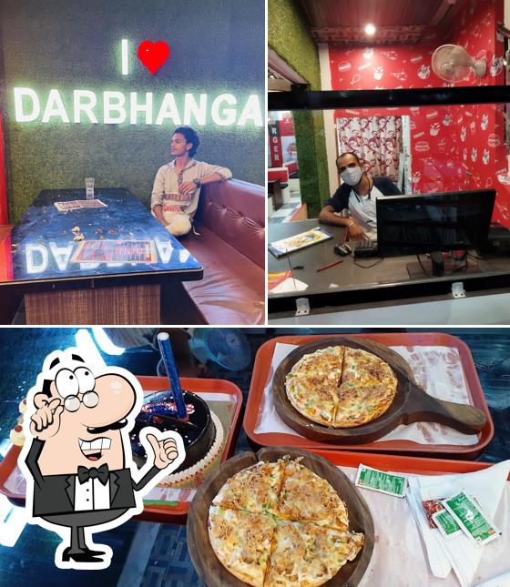 The photo of interior and pizza at Al-Baik.Com