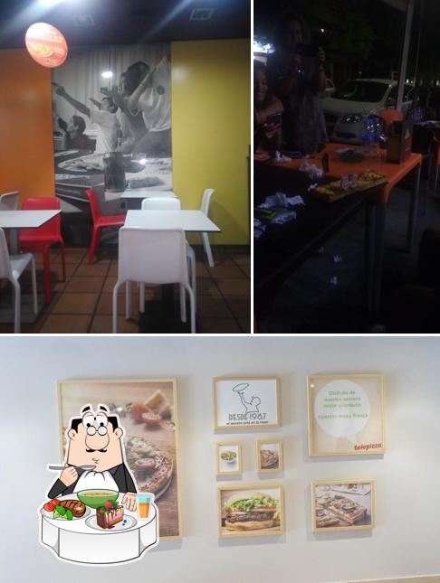 Check out the image displaying dining table and burger at Telepizza Martorell - Comida a Domicilio