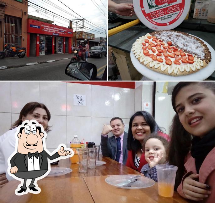 Sente em uma das mesas no Iedita Pizzaria e Pastelaria