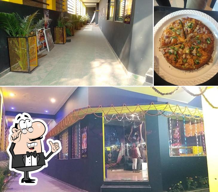 Check out the image showing interior and pizza at Jadooz Cinema and VR, Nichlaul, Uttar Pradesh